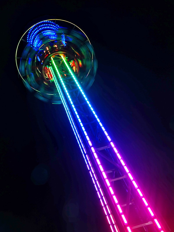 drop tower with lights at night